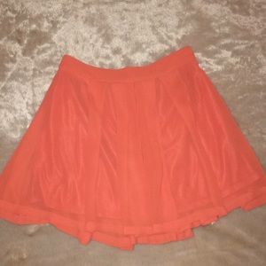 Orange pleated mini skirt